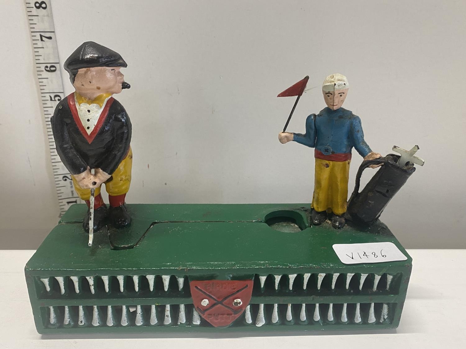 A novelty cast iron vintage money box entitled Birdie Putt