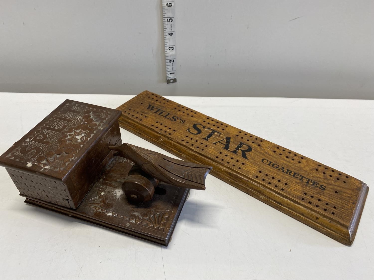 A vintage wooden novelty cigarette dispenser and a Wills cigarettes cribbage board