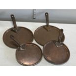 A selection of antique copper sauce pan lids