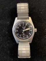 A watch in the style of a Smiths 6B/346 RAF military watch, with broad arrows to dial and case back,