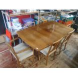 A mid century 1960's Gordon Russell Dining Table complete with 6 chairs (two with armrests). Table