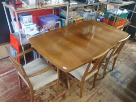 A mid century 1960's Gordon Russell Dining Table complete with 6 chairs (two with armrests). Table