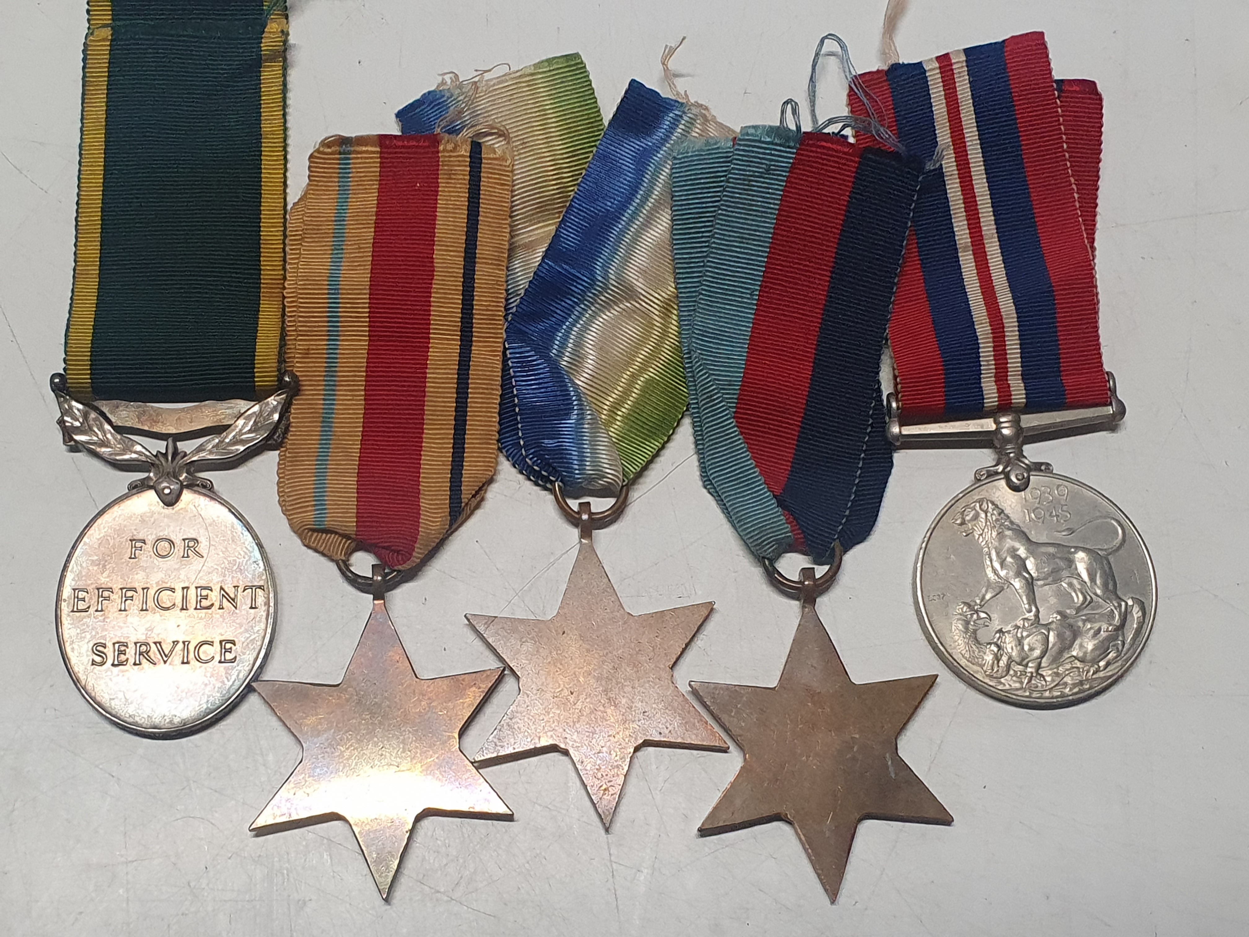 A grouping of WW2 medals & a Territorial efficiency medal awarded to Craftsman J Stringer Royal - Image 5 of 5