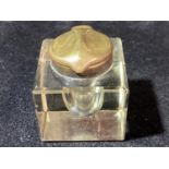 A antique brass topped glass ink well.