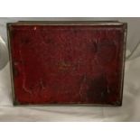 A collectible American Schraffts crimson chest biscuit tin