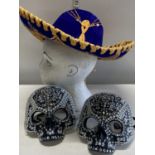 A Mexican style hat and two skull masks. Shipping unavailable