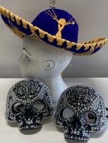 A Mexican style hat and two skull masks. Shipping unavailable