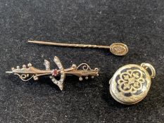 A 9ct gold stick pin and a 9ct gold brooch (gross weight 3.37g) with a yellow metal mourning locket