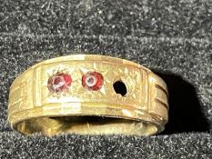 A heavy 9ct gold ring with two rubies (one missing) 7.66 grams.