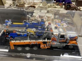 A Lego Technic Heavy Duty Tow Truck model 42128 in display case, with original box etc, shipping