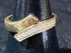 A 9ct gold & diamond cross over ring. 2.14 grams