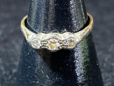 A 9ct gold and three stone diamond ring. 1.38 grams
