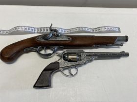 A replica wall hanging pistol and one other