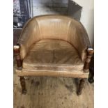 A antique leather arm chair with wooden framework. Shipping unavailable