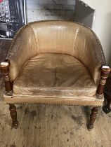 A antique leather arm chair with wooden framework. Shipping unavailable