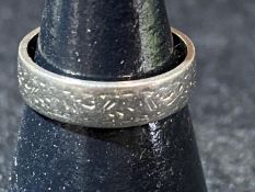 A 18ct white gold band ring with etched design. 3.15 grams