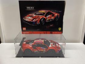 A Lego Technic Ferrari 488GTE model 42125 in display case, with original box etc, shipping