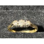 A 18ct gold & three stone diamond ring. 1.82 grams