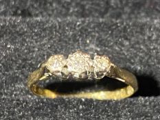 A 18ct gold & three stone diamond ring. 1.82 grams