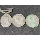 Two collectible £5 coins and a George V India Efficiency medal awarded to PTE J Slade 2nd battalion,