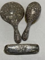 A hallmarked silver hair brush and two other silver plated pieces.