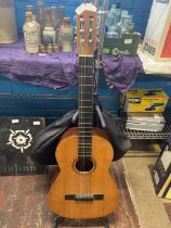 A Spanish acoustic guitar complete with stand and carry case, shipping unavailable