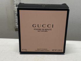 A boxed Gucci beauty powder compact