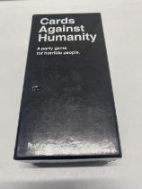 A boxed set of Cards Against Humanity (unchecked)