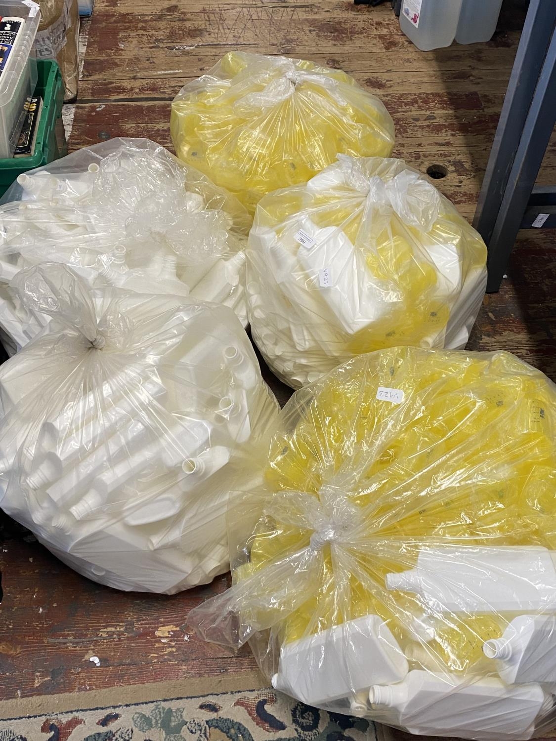 Five bags full of new plastic bottles all with caps, shipping unavailable