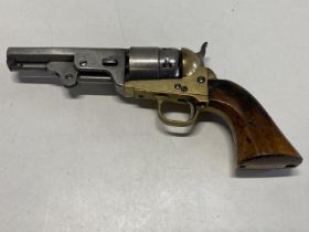 A reproduction 1849 Colt pocket muzzle loading revolver with a leather holster. Curret Firearms
