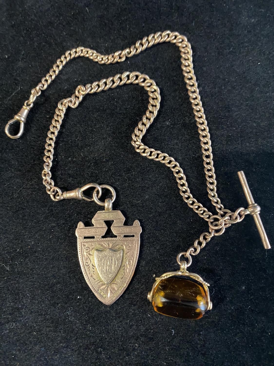 A 9ct gold double Albert chain with a spinning fob and a 9ct gold pendant, total weight 35.18g