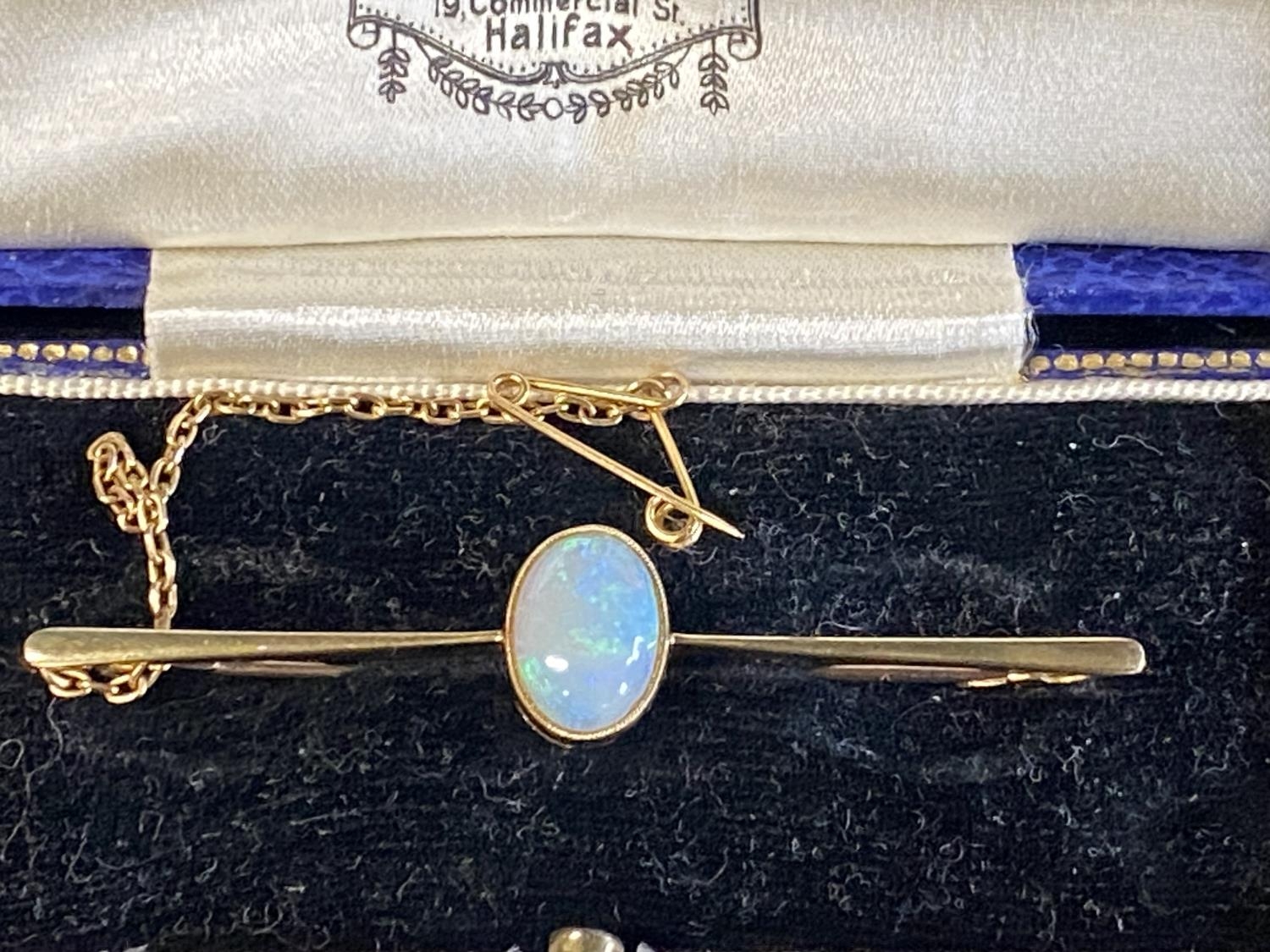A 14ct gold and opal bar brooch in original box 4.10g