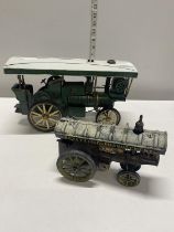 One tin plate steam engine model and one smaller cast iron tin plate model