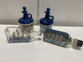 Two vintage ships in a bottle with two ceramic Lambs Navy Rum decanters, shipping unavailable