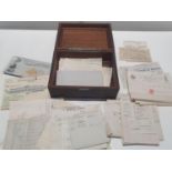 A vintage wooden box with contents of assorted ephemera