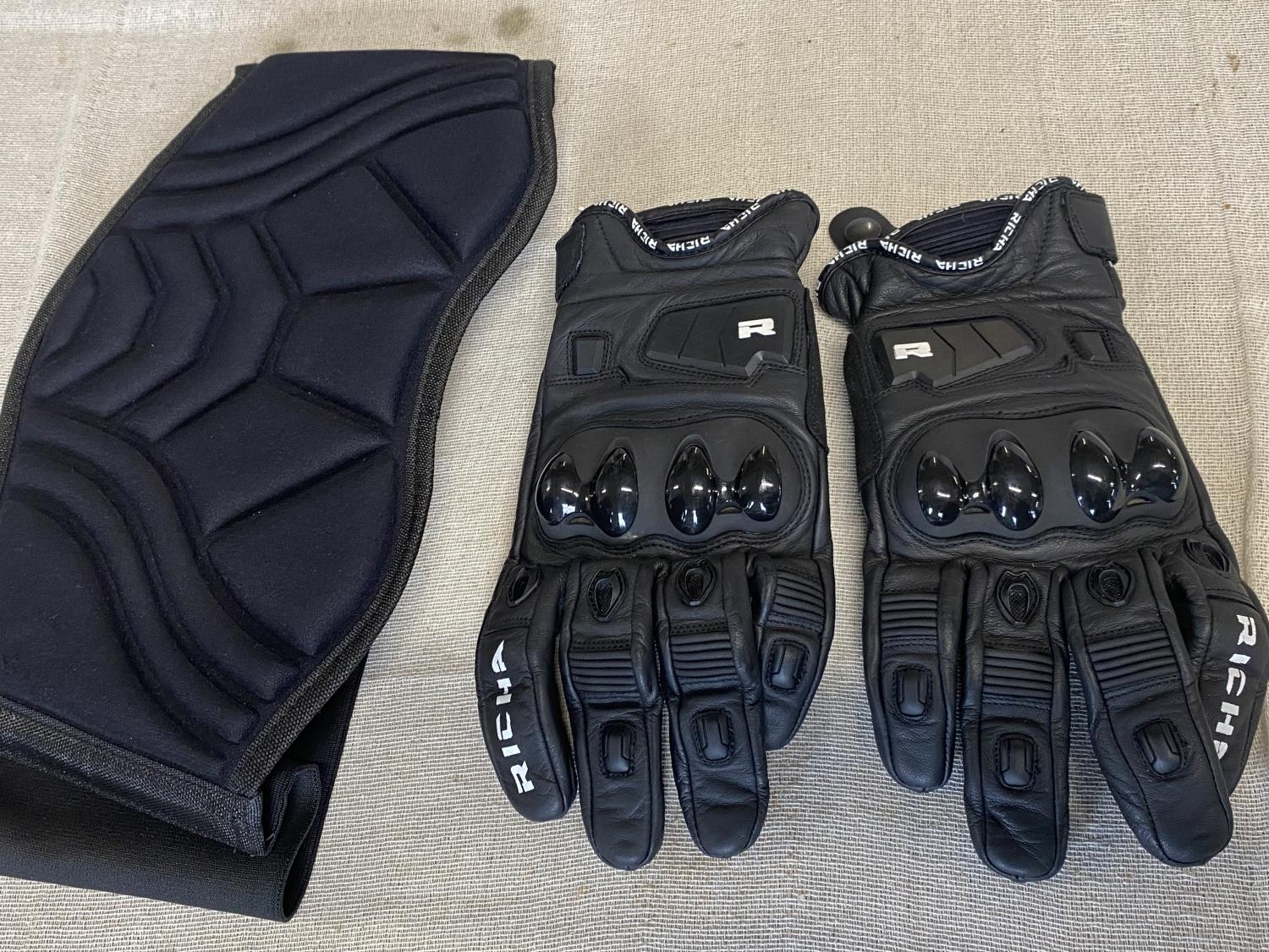 A pair of Riccha motorbike gloves and back brace