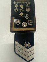 A collection of vintage boys brigade metal badges and arm bands etc