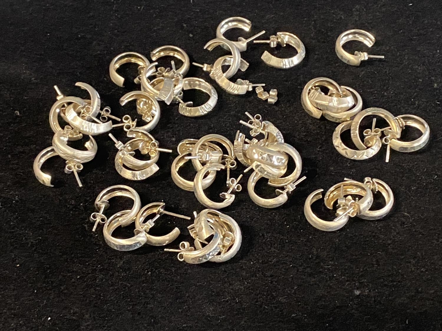 A large collection of new white metal earrings