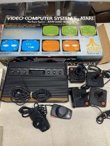 A boxed Atari Computer console model number CX-2600. With controllers etc.