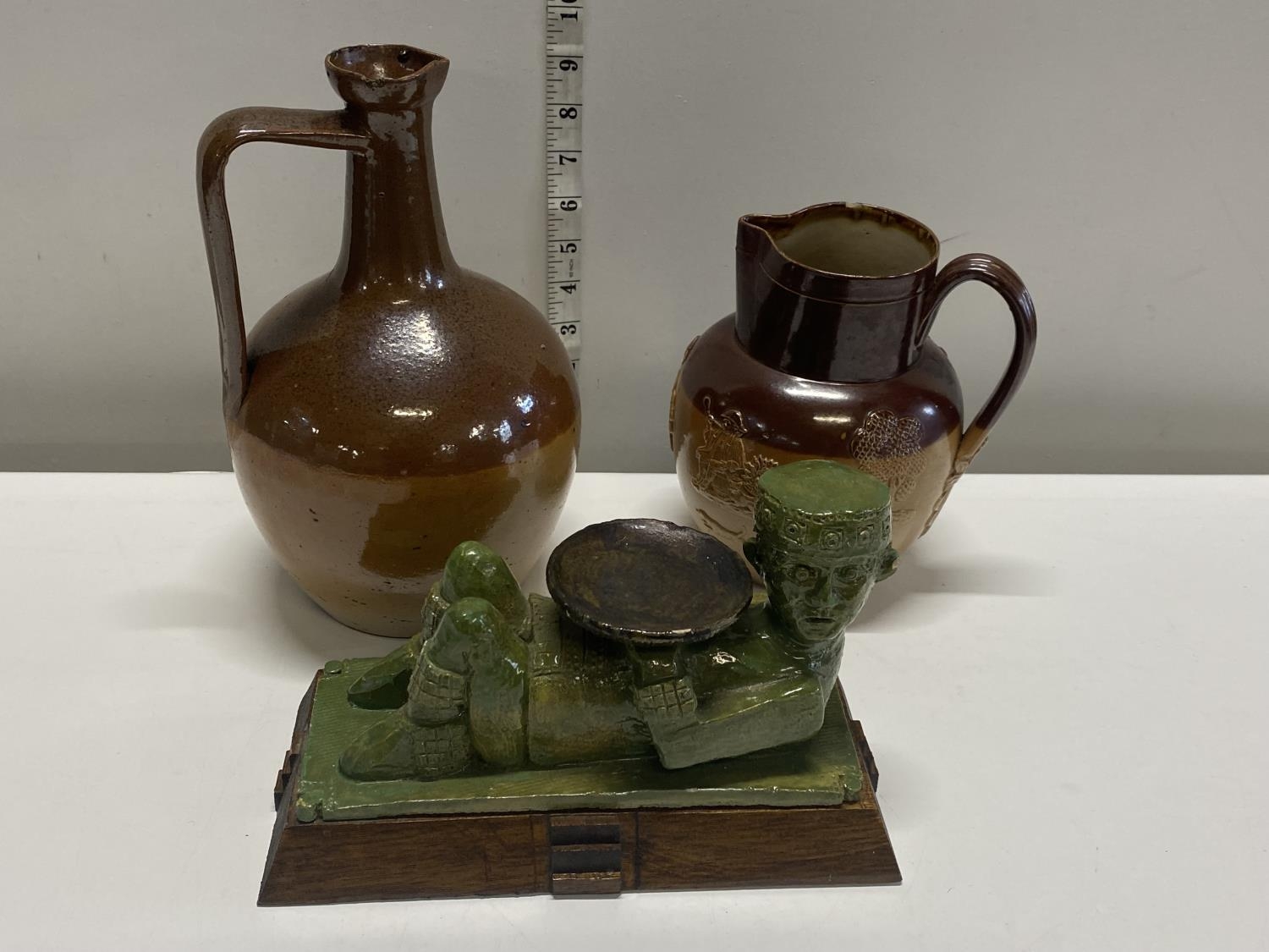 Two salt glazed antique jugs and a unusual ceramic and wooden figurine, shipping unavailable