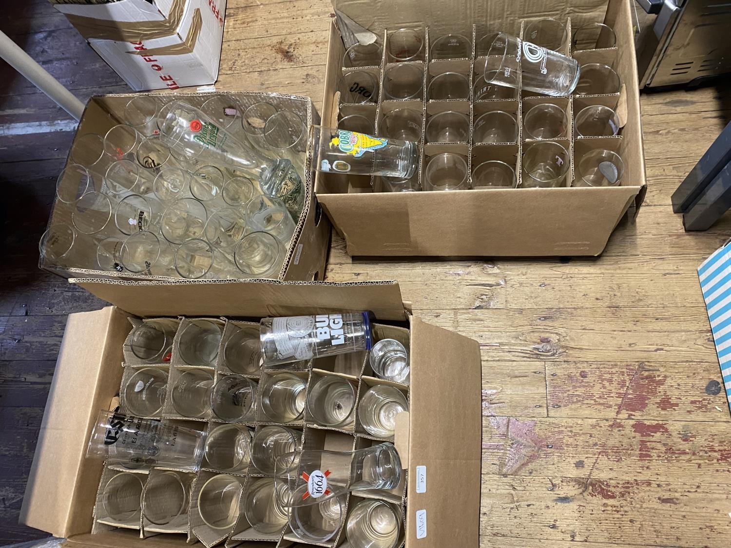 Three boxes of various advertising beer glasses, shipping unavailable