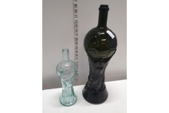 Two glass bottles in the form of The FIFA World Cup produced for Italia 1990 tallest 47cm,