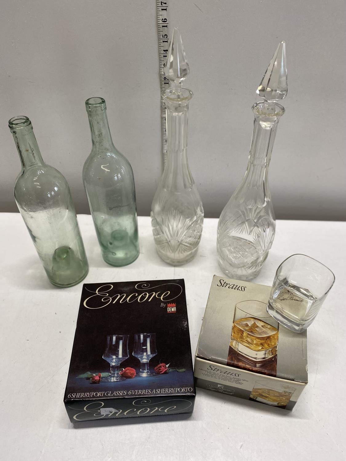 A box of assorted glassware including a pair of decanters, shipping unavailable