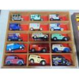 Fifteen assorted die-cast models in a wooden display rack