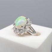 An exciting platinum opal and diamond halo cluster ring