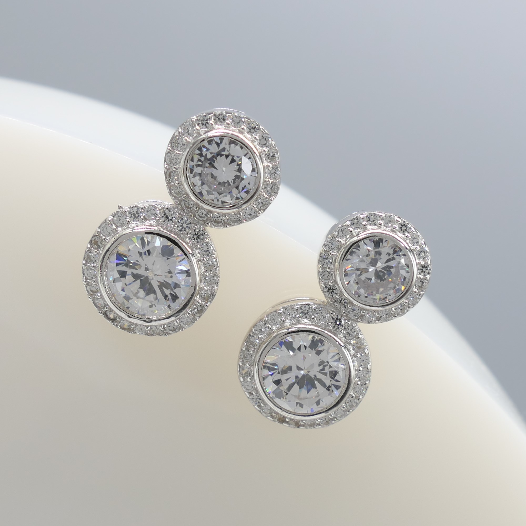 Gem-set double halo droplet earrings in silver