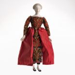 A doll, in ESCADA dress - Head, arms and legs made of Nymphenburg porcelain. Later formation after a