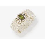 A four-strand cultured pearl bracelet with peridot clasp - Germany, circa 1915