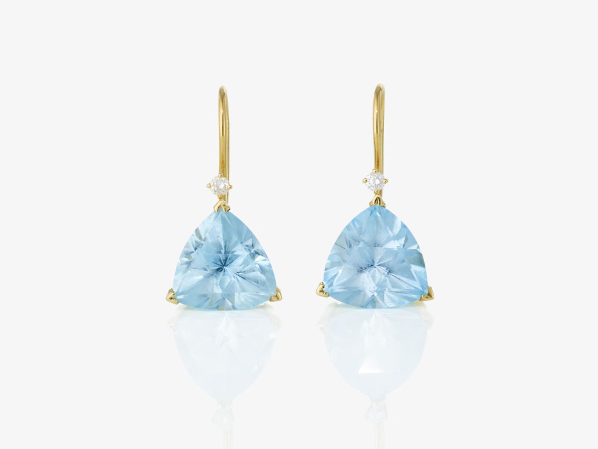 A pair of earrings with light blue topazes and brilliant-cut diamonds