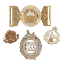 A WAISTBELT-CLASP AND THREE BADGES